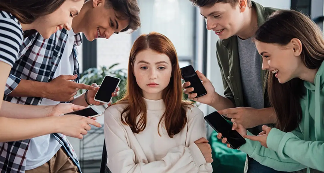 a girl surrounded by people with smartphones