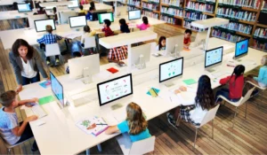 a library with tables where people are using computers